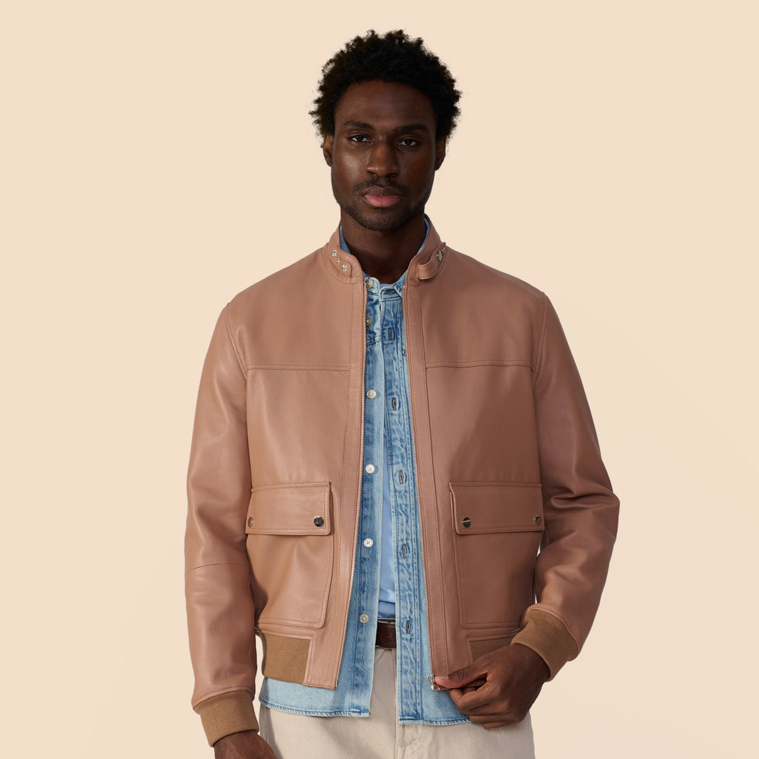Image of a man wearing a brown leather jacket showcasing men's leather jackets by Furniq