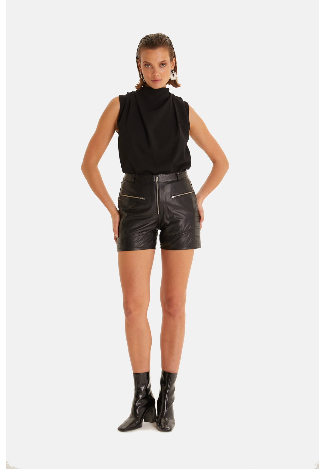 Woman wearing black leather shorts