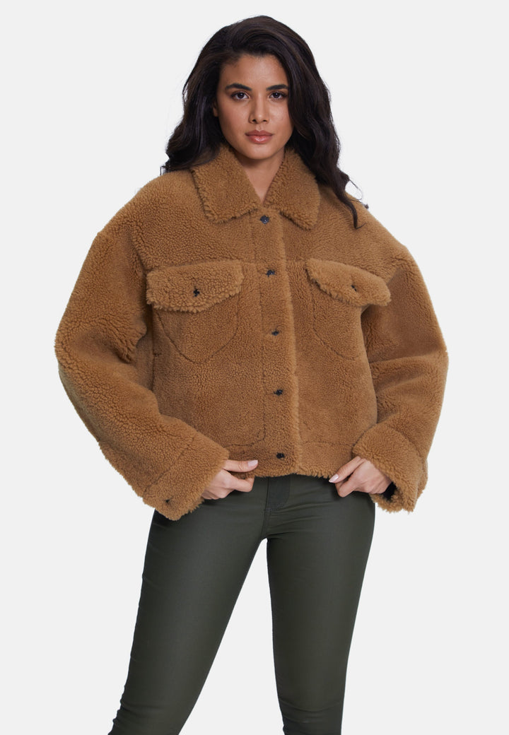 Woman wearing brown teddy jacket