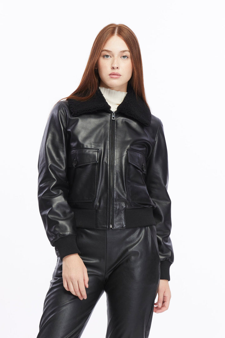 Woman wearing black leather bomber jacket