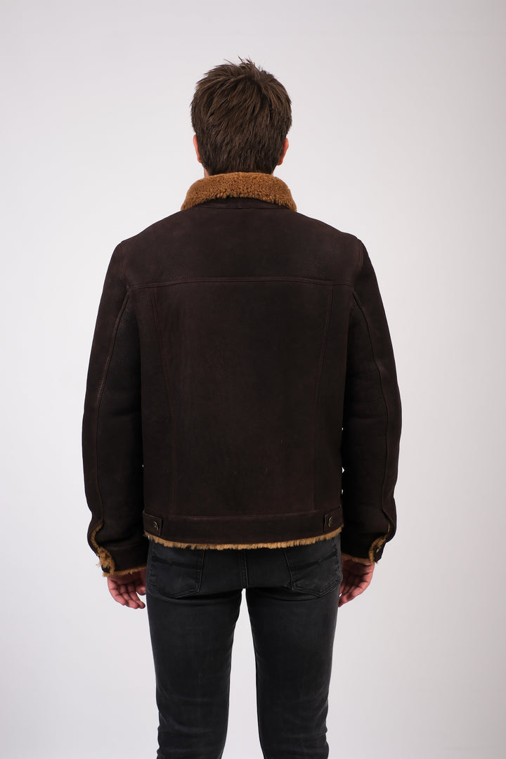 Man wearing brown shearling jacket - back view