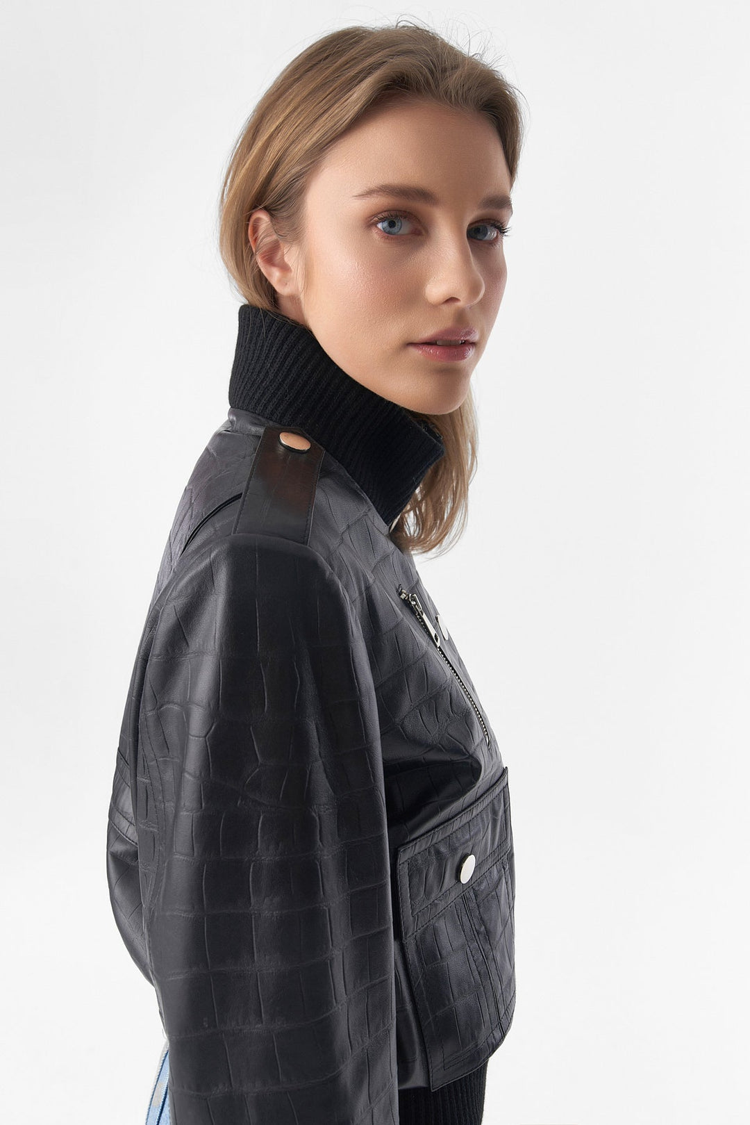 Woman wearing black faux-croc bomber jacket