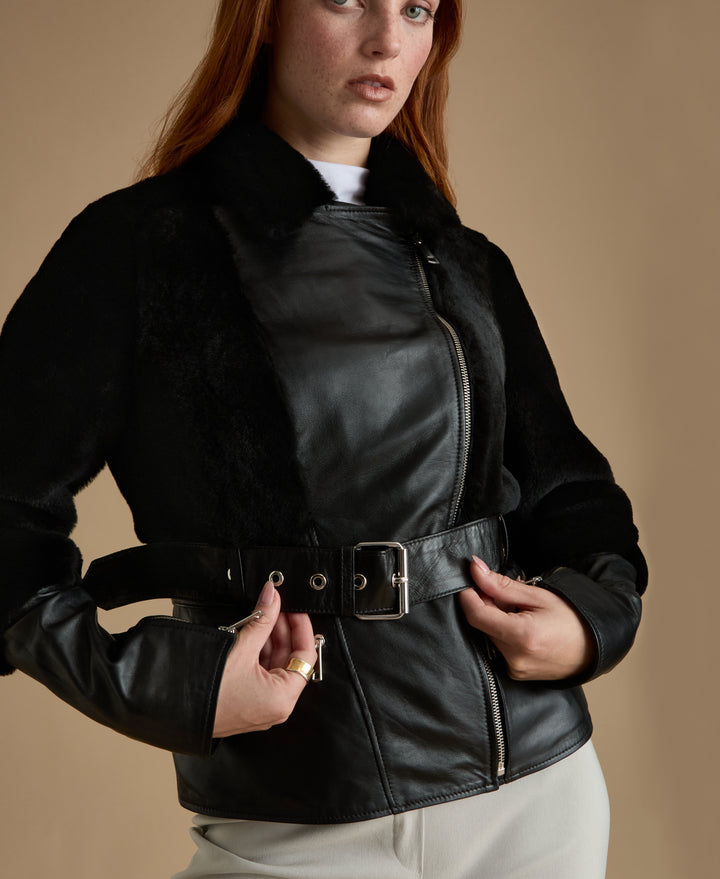 Woman wearing black belted leather jacket