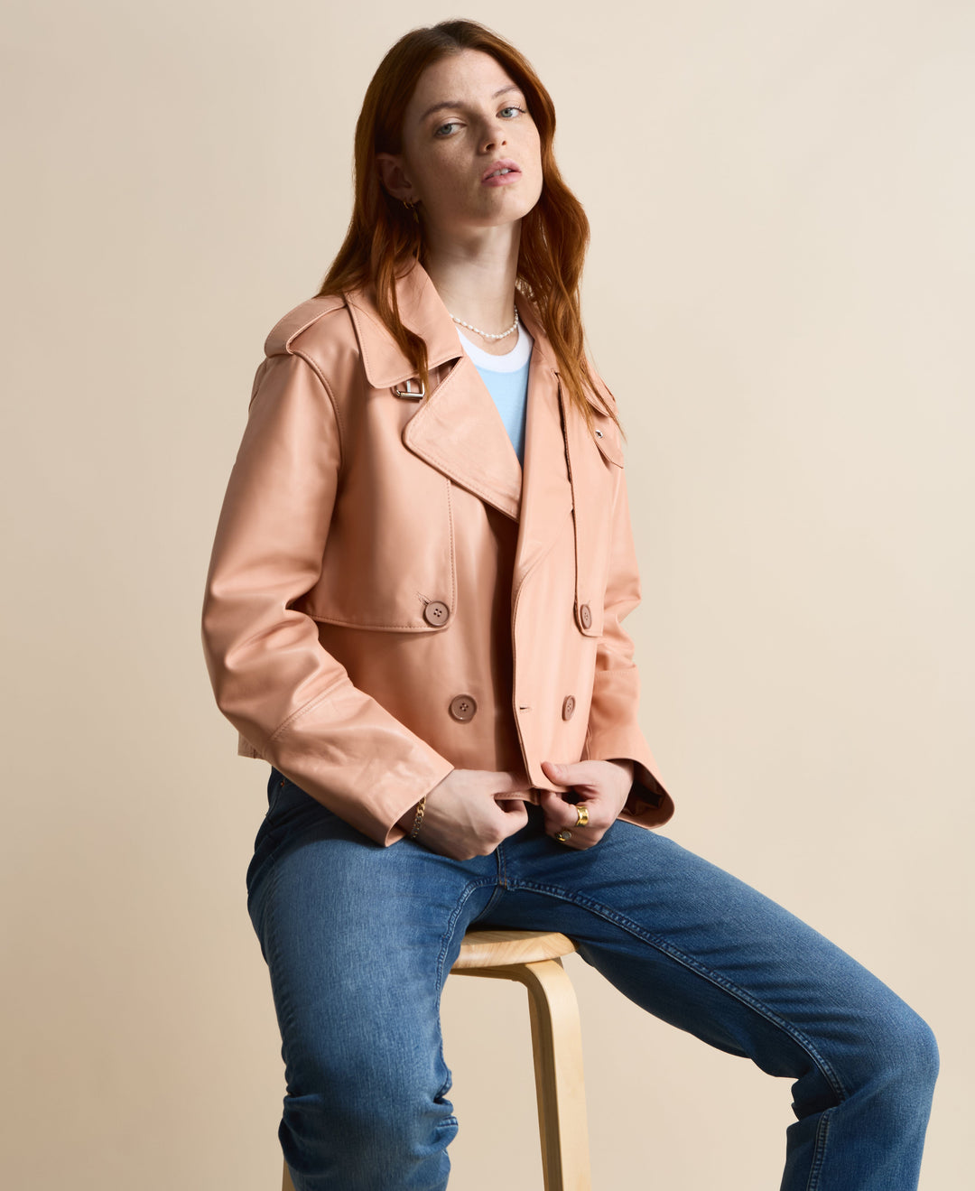 Peach leather jacket on seated model