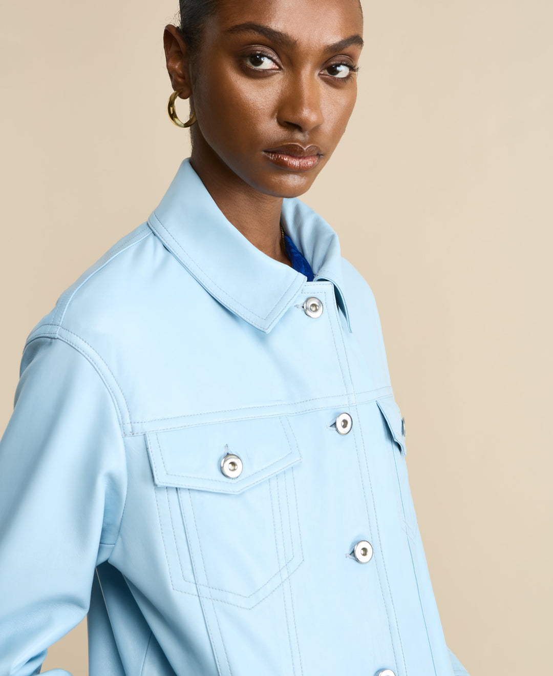 Light blue leather shirt jacket on model