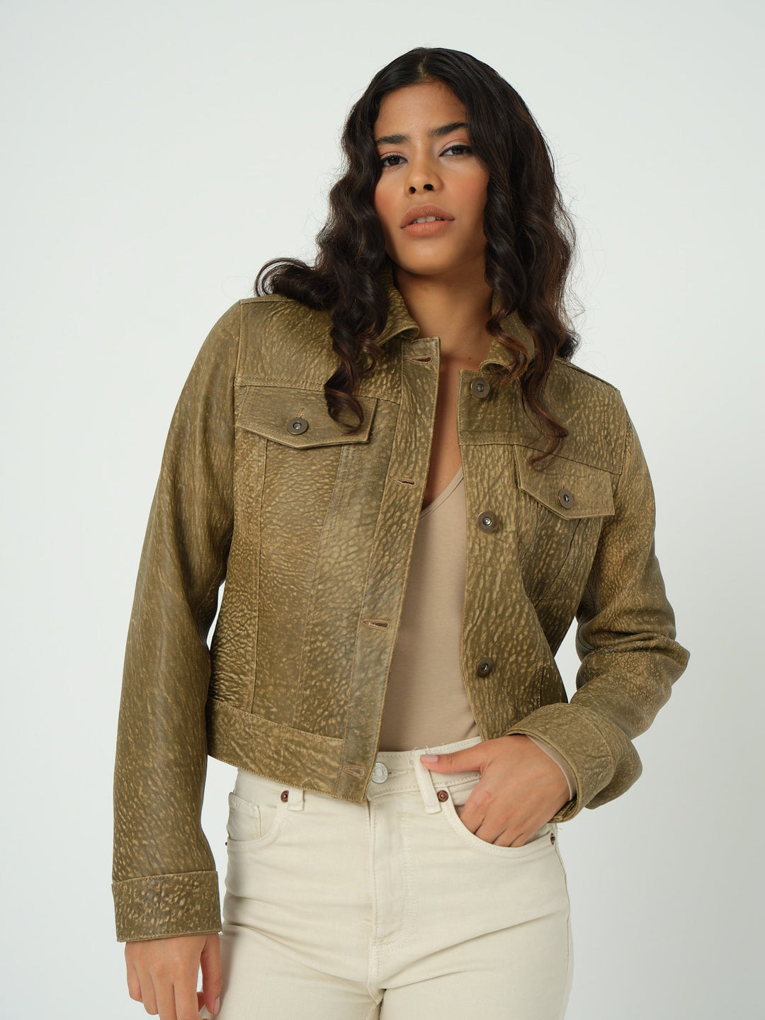 Woman wearing brown cropped leather jacket