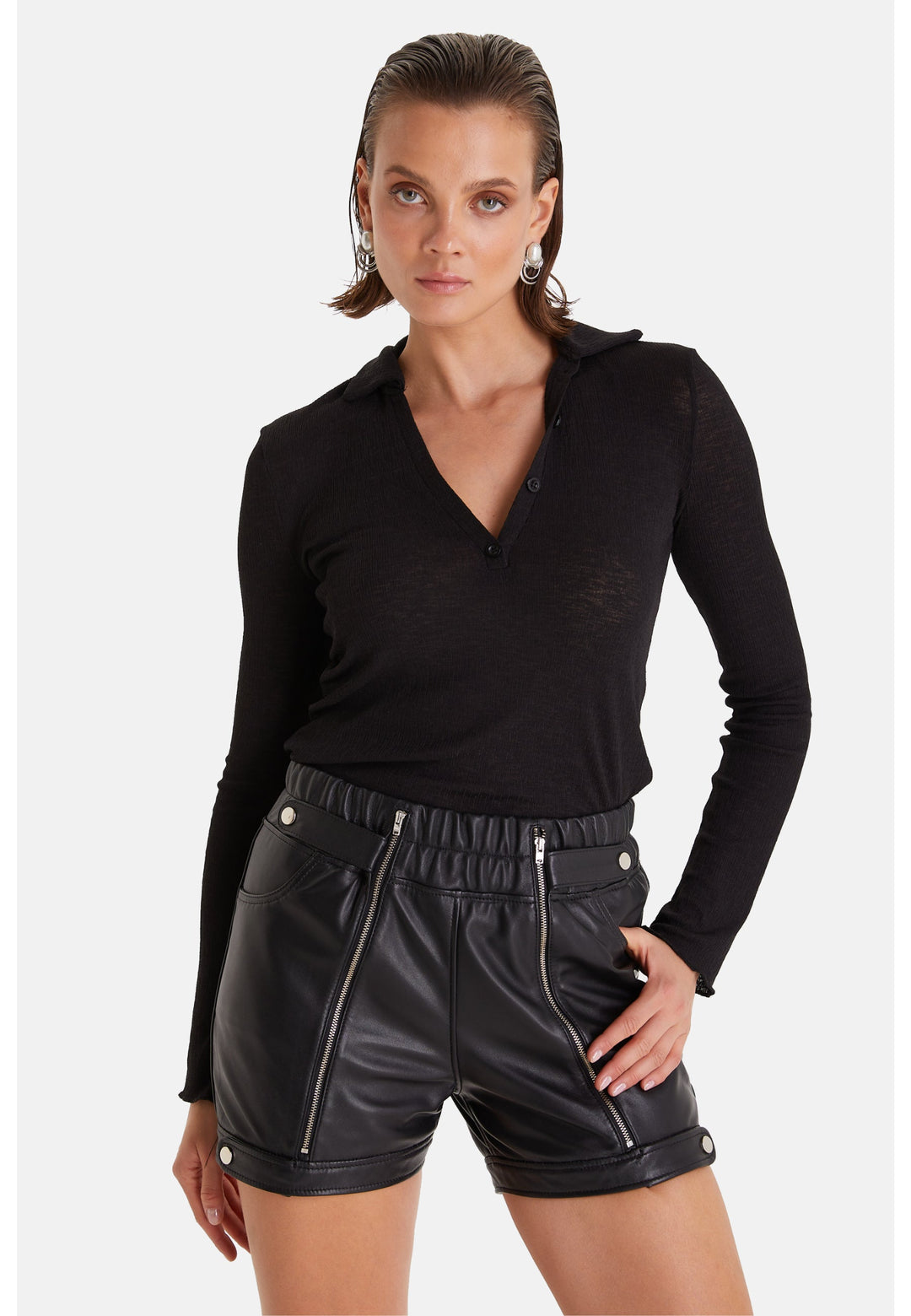 Woman wearing black leather shorts