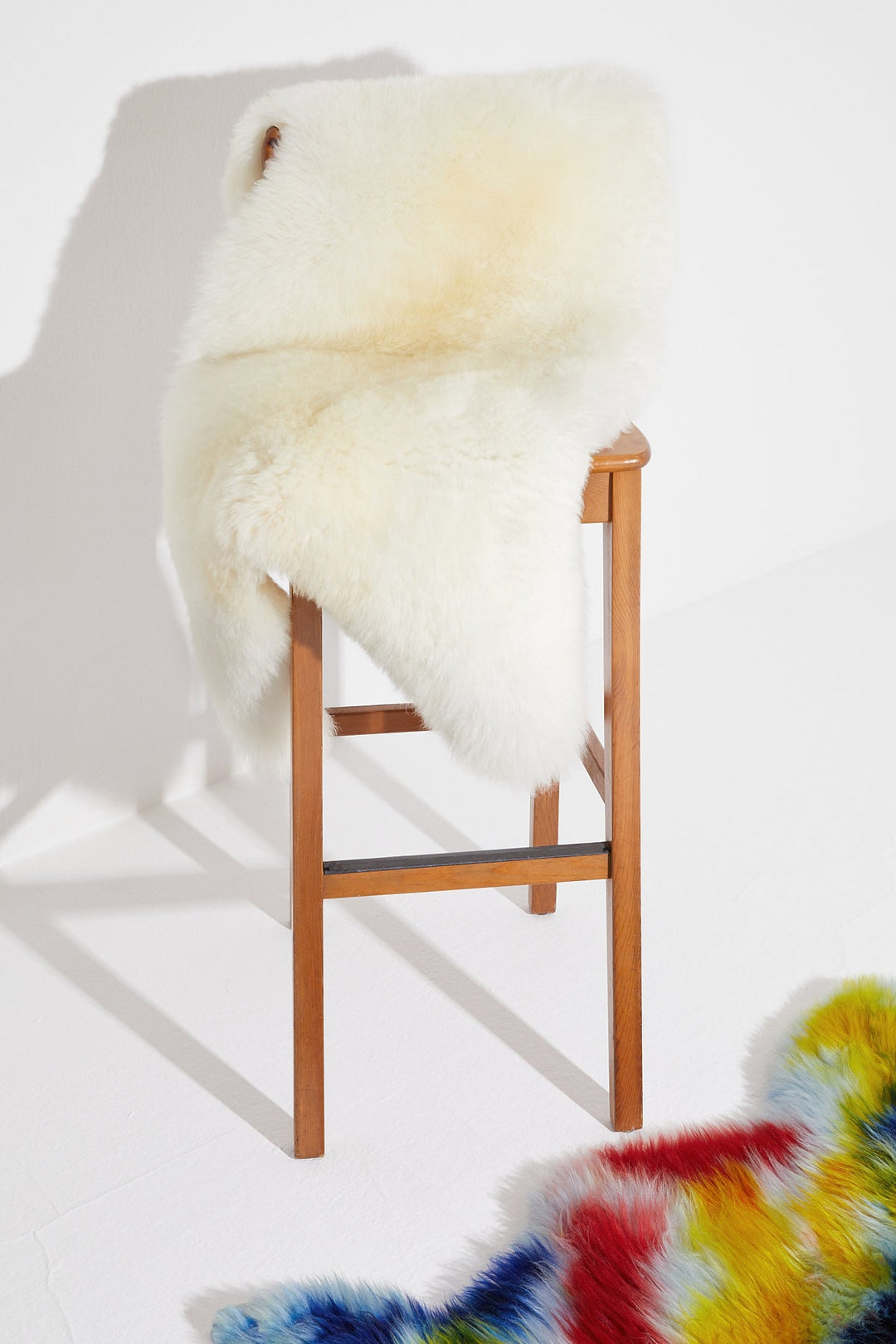 Natural white sheepskin rug on stool