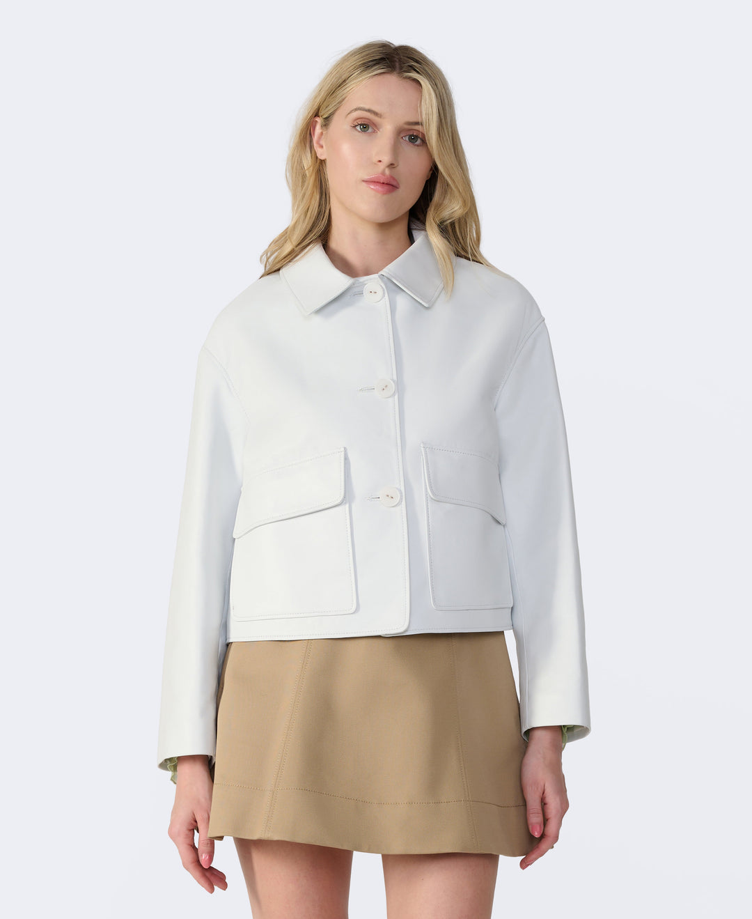 Woman wearing white cropped leather jacket