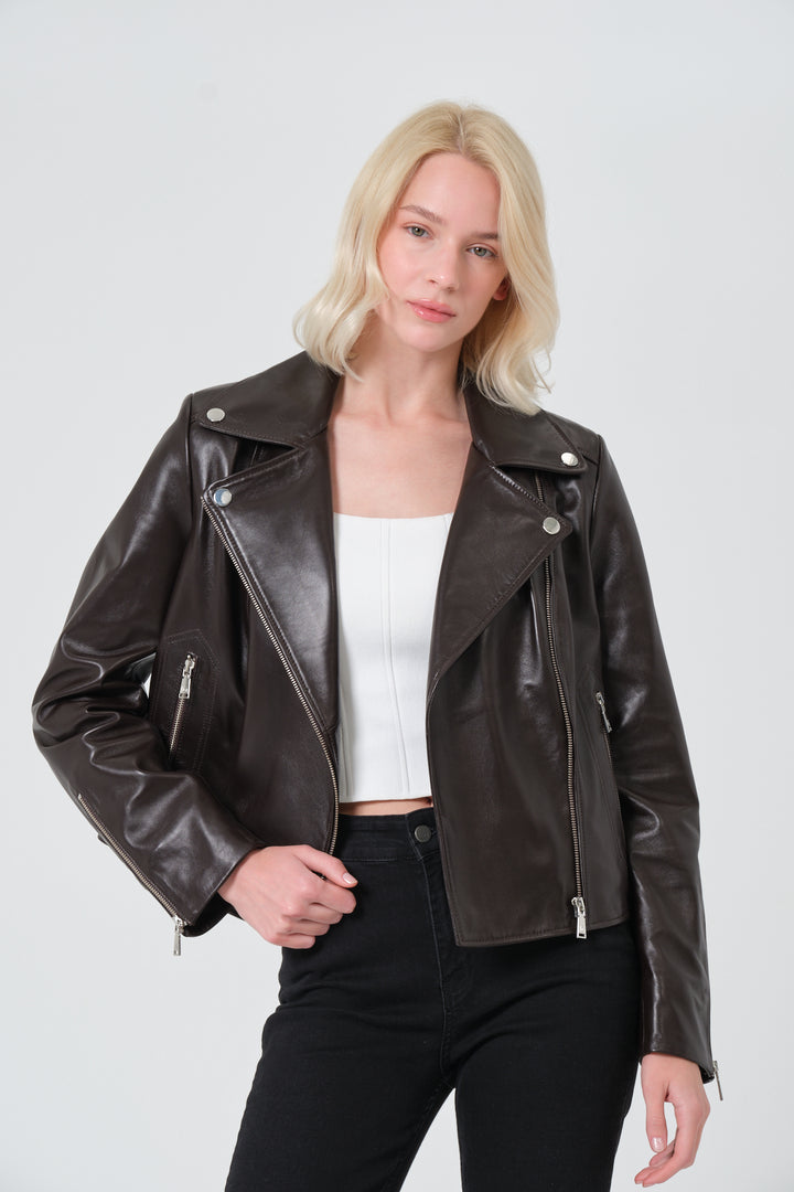 Woman wearing a brown leather jacket on a white background