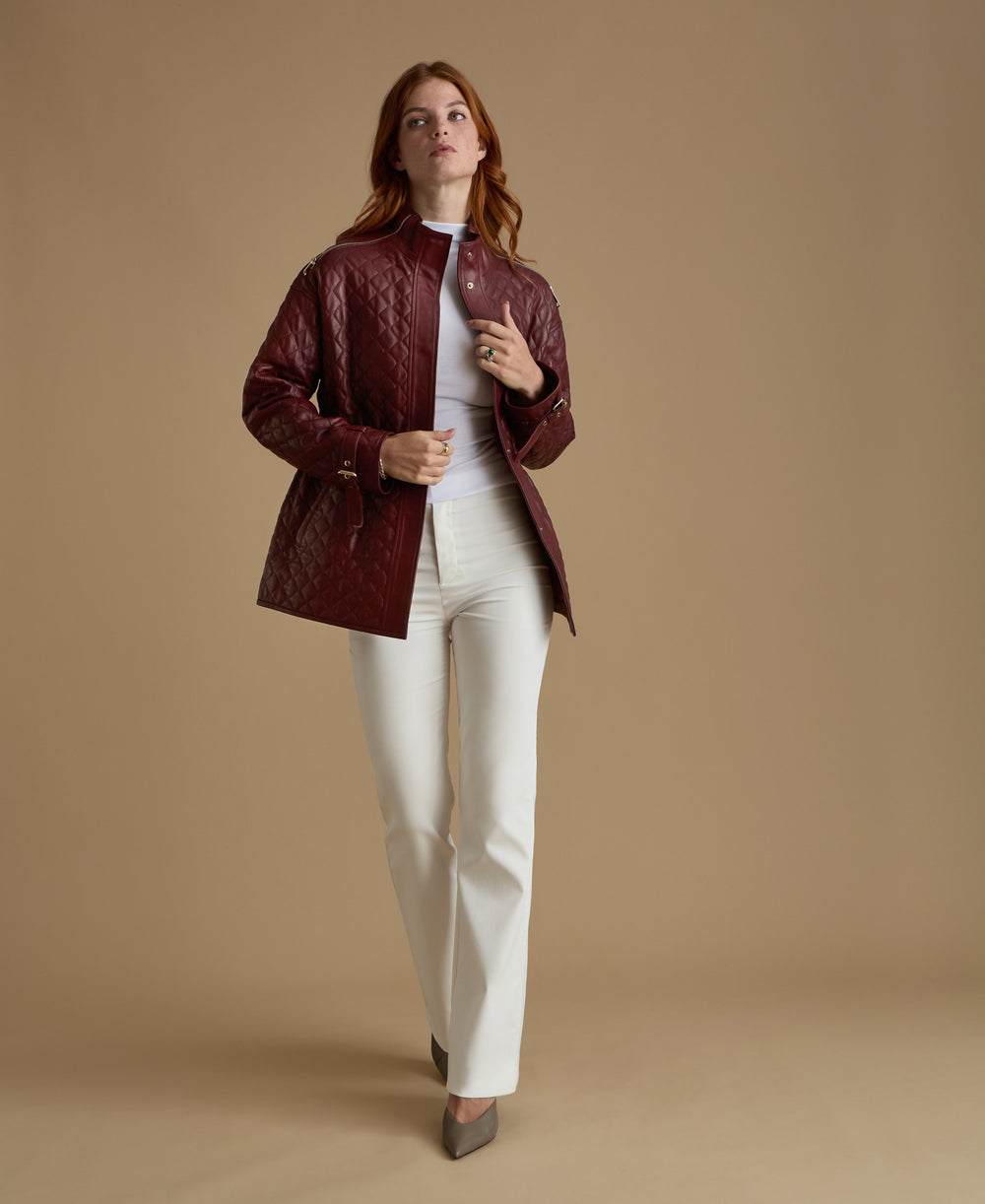 Woman wearing burgundy quilted leather coat