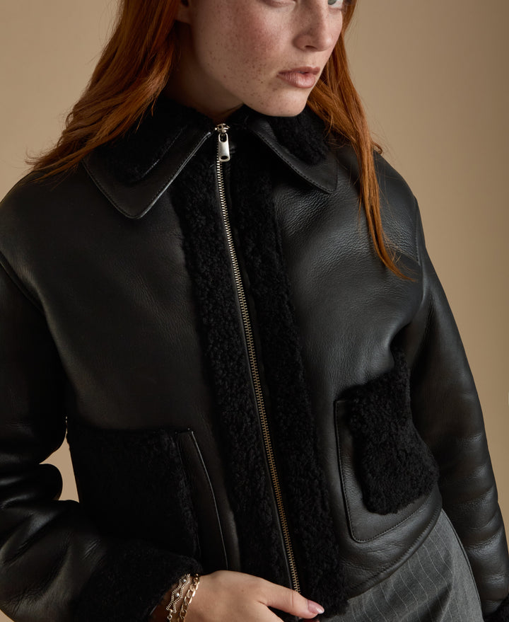 Black shearling leather jacket on model