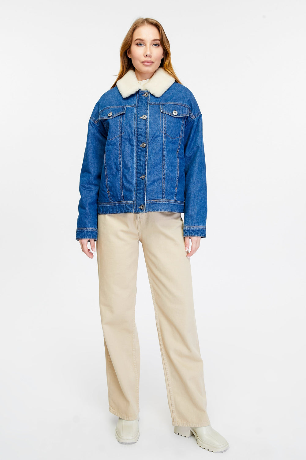Woman wearing blue denim jacket with shearling collar