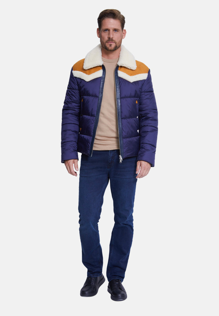 Man wearing navy puffer coat with shearling collar