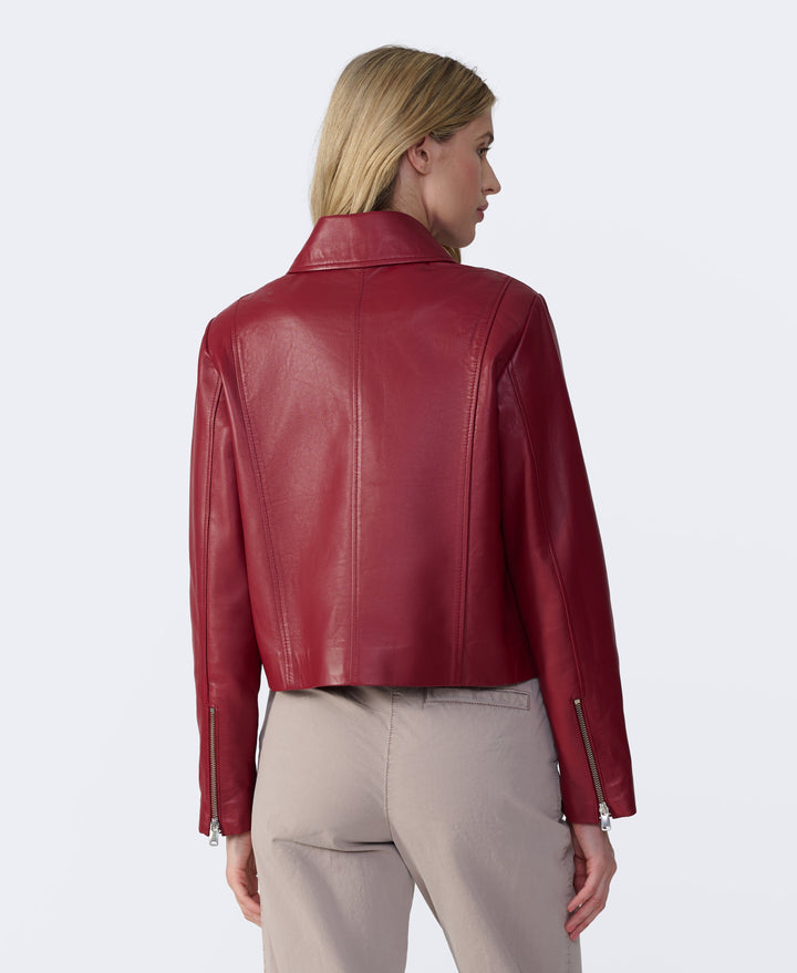 Woman wearing red leather jacket - back view