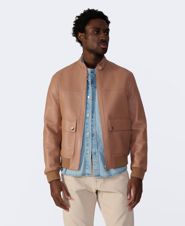 Tan leather bomber jacket on model