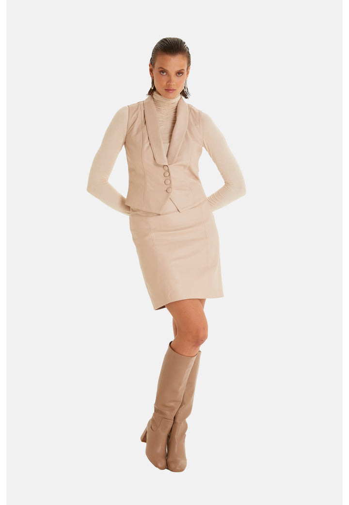 Woman modeling beige leather vest outfit