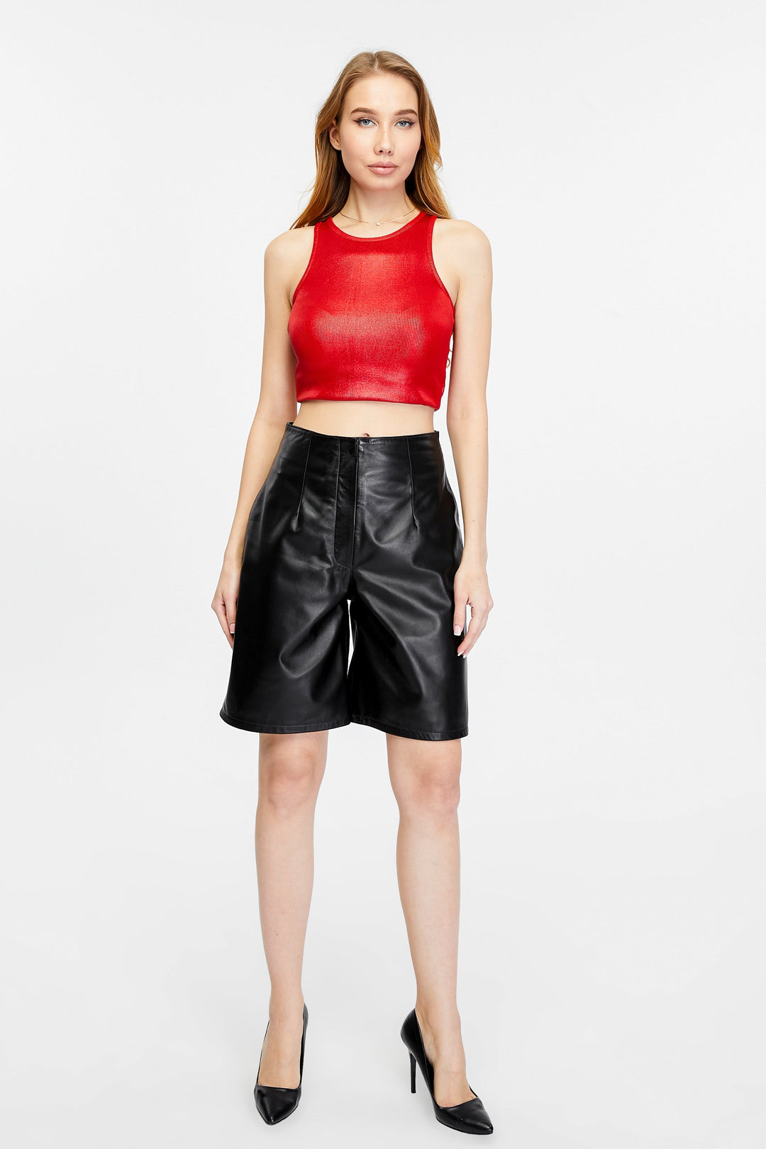 Woman wearing black leather shorts