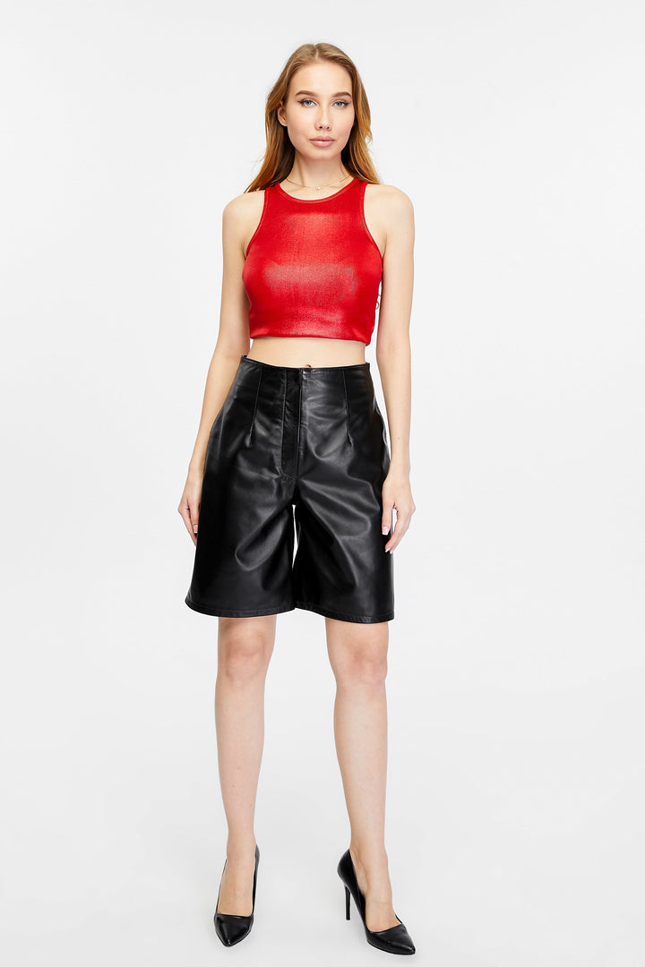 Woman wearing black leather shorts