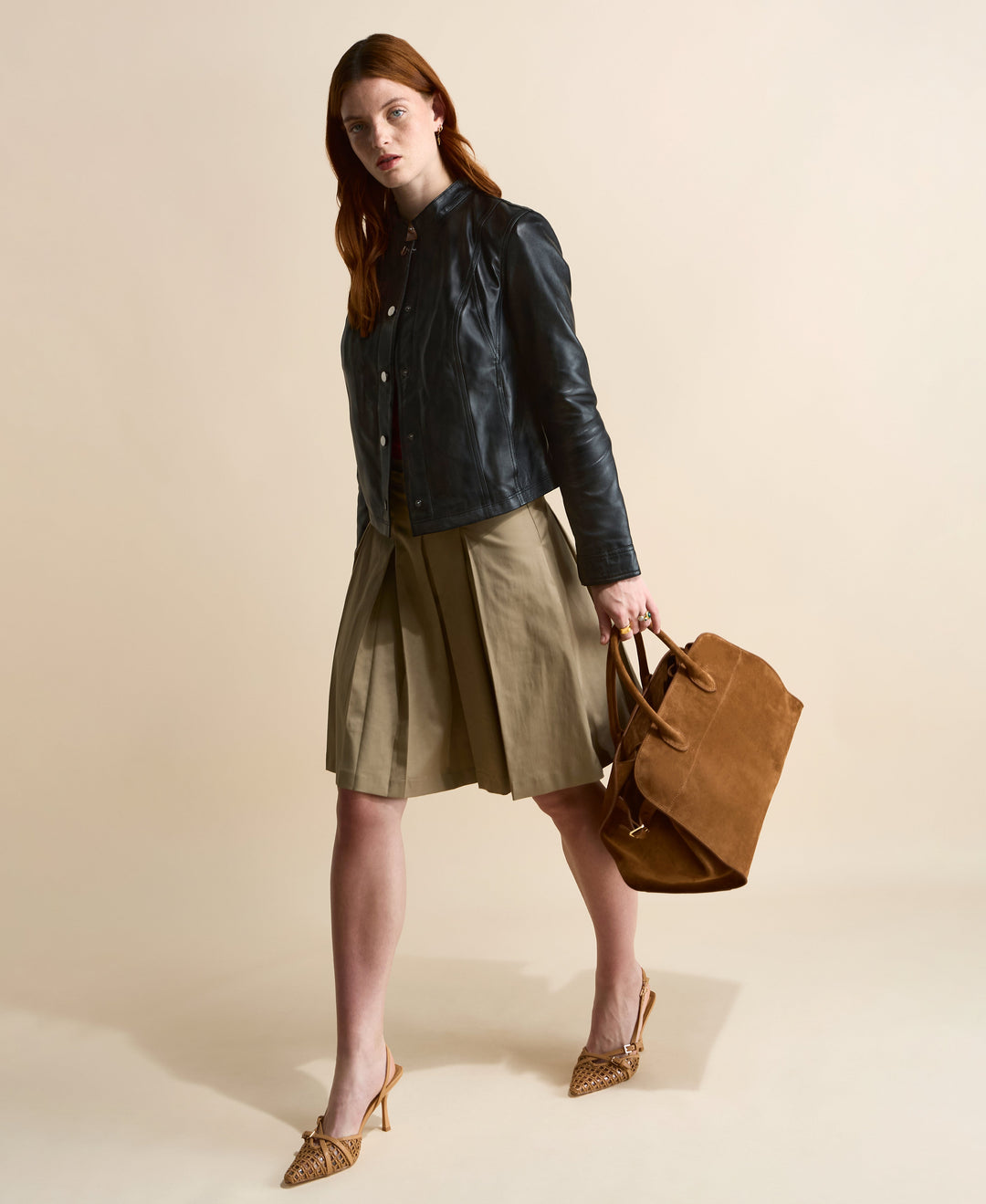 Model wearing navy leather jacket