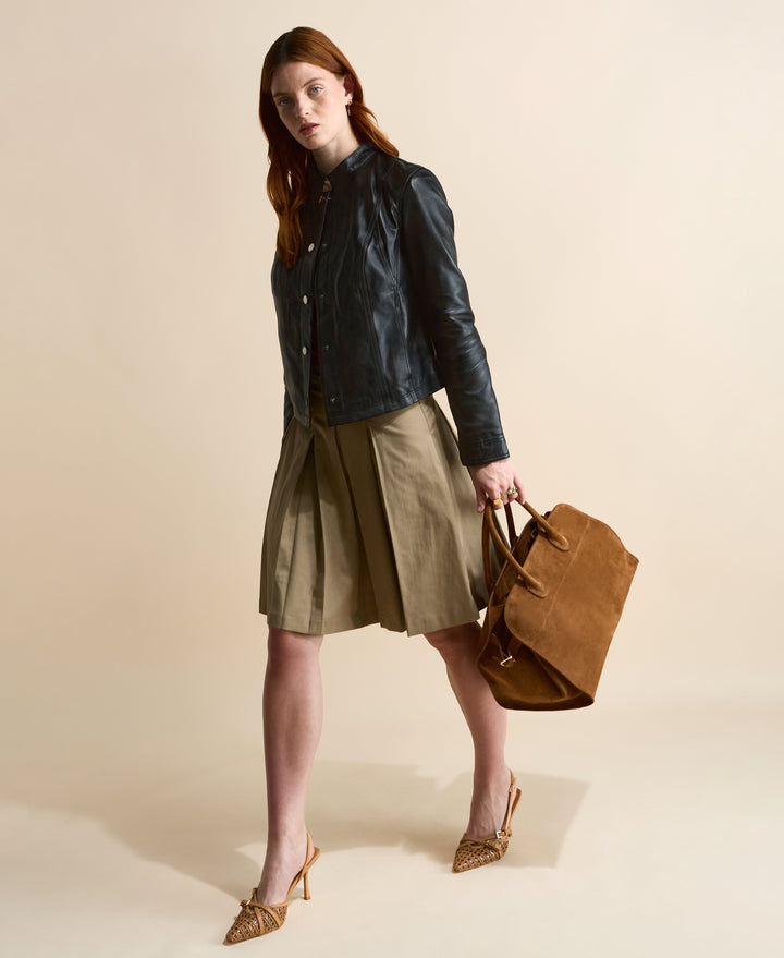 Model wearing navy leather jacket