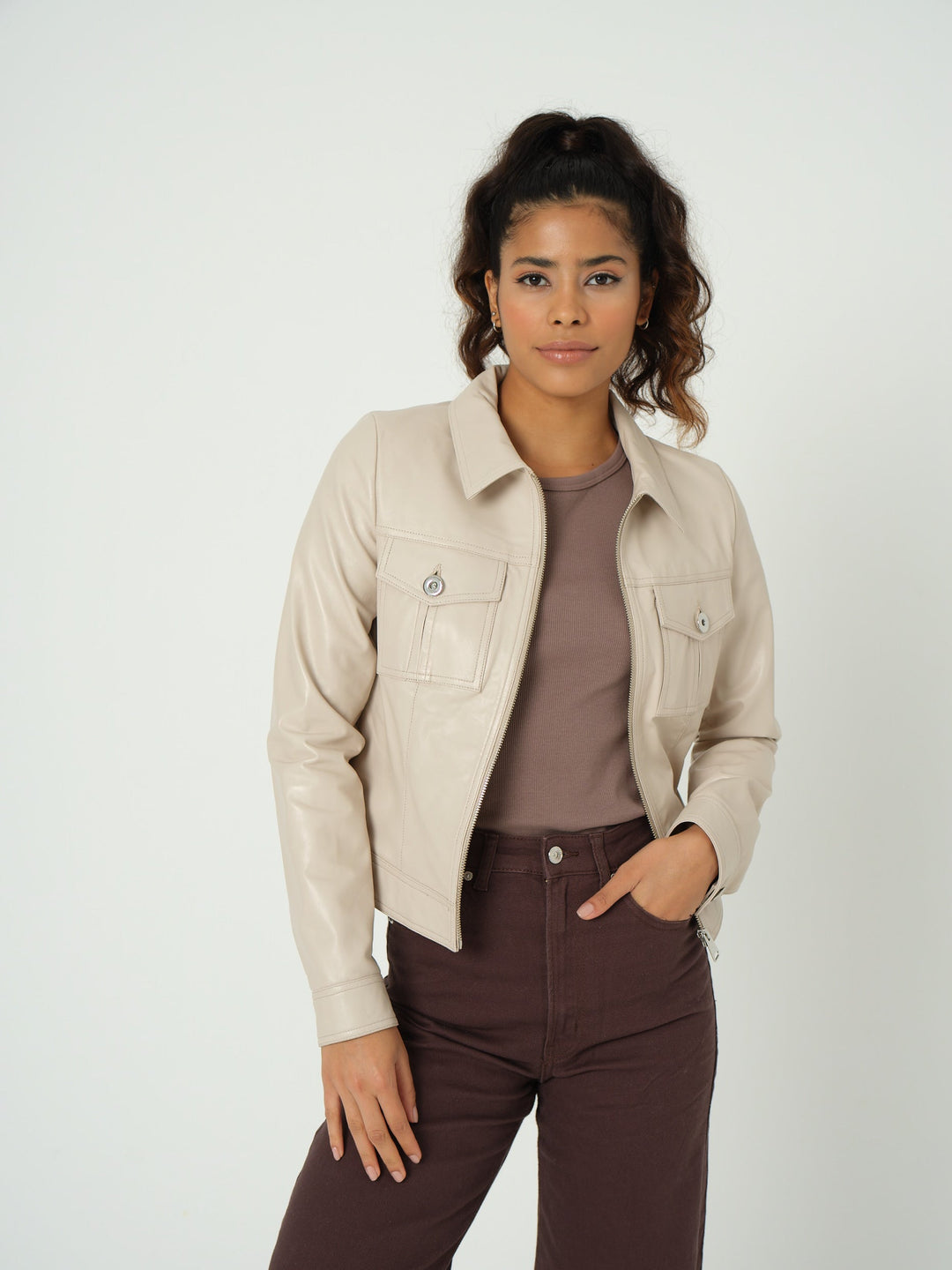 Woman wearing beige cropped leather jacket