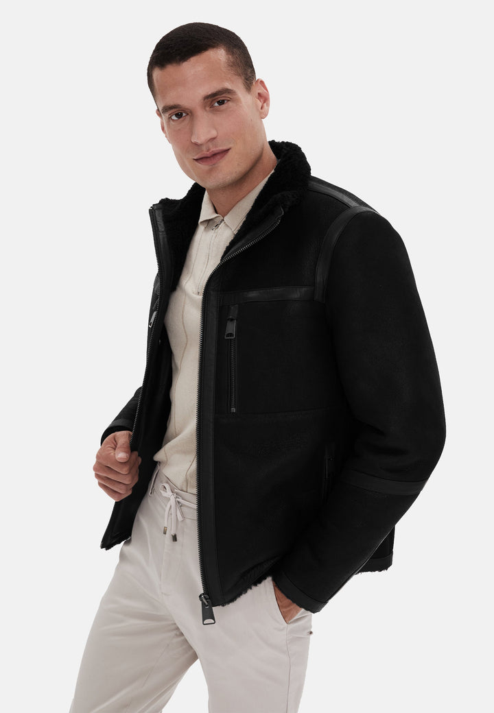 Male model wearing black shearling jacket