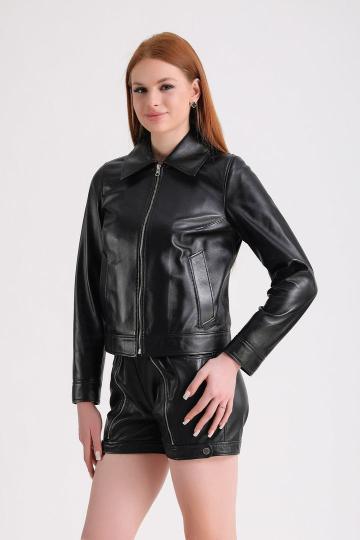 Woman in black leather jacket and shorts