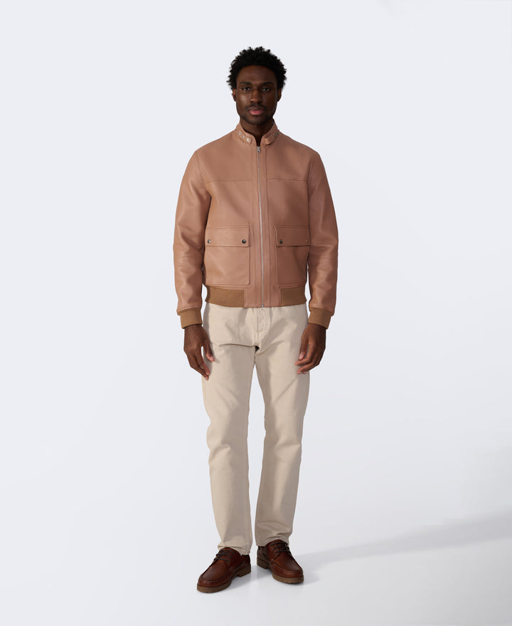 Tan leather bomber jacket on model