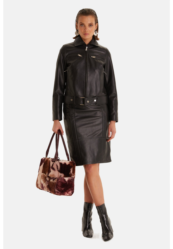 Woman wearing black leather jacket and skirt