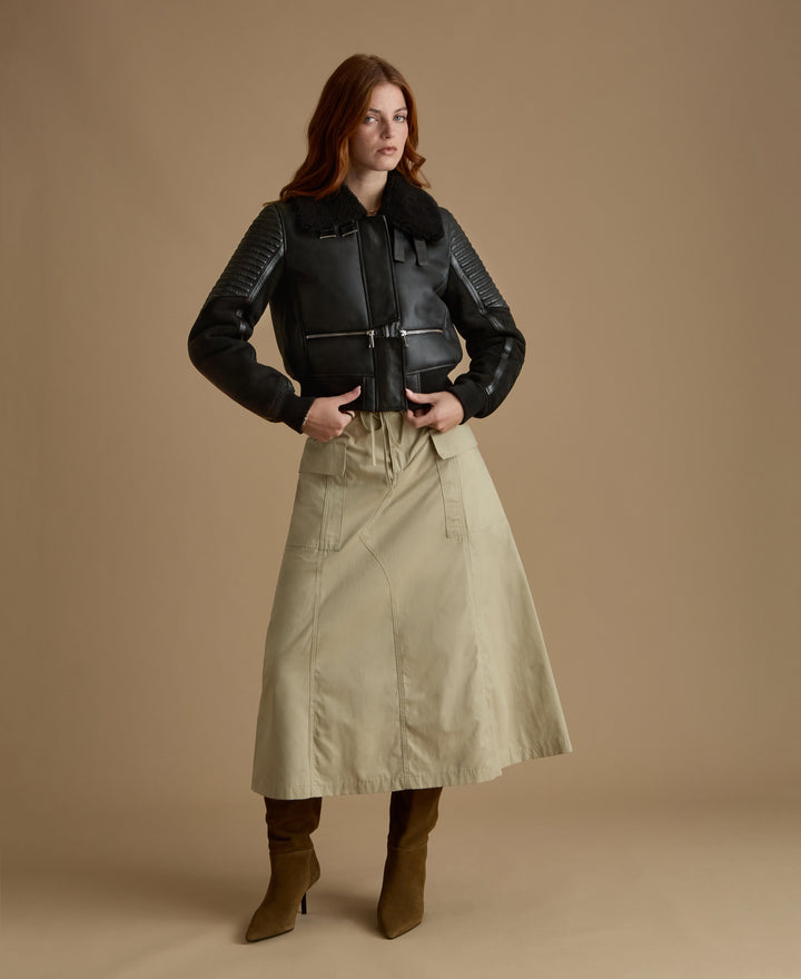 Woman wearing black shearling jacket