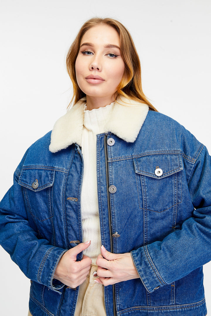 Woman wearing blue denim jacket with shearling collar