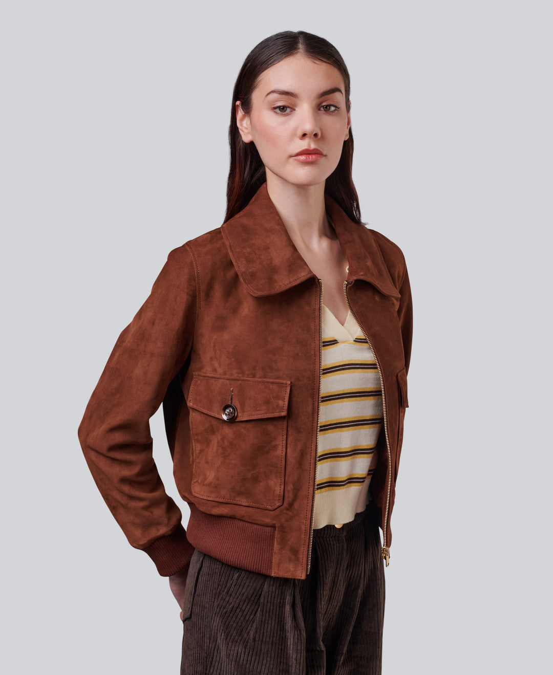 Woman wearing rust suede bomber jacket
