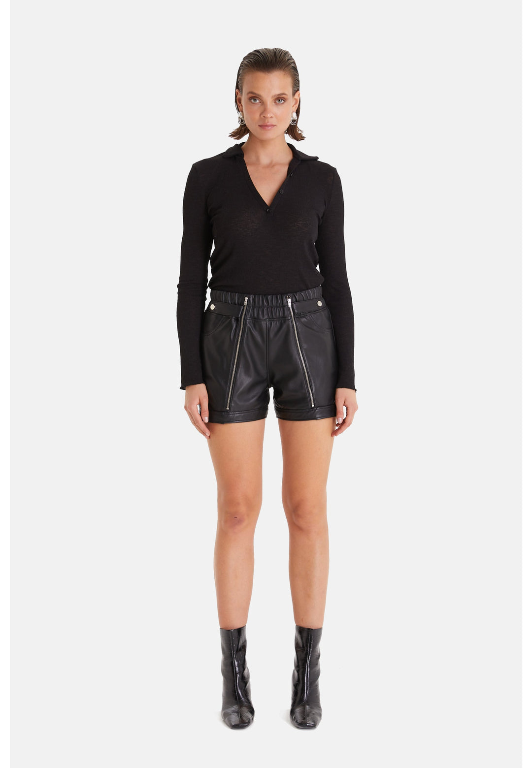 Woman wearing black leather shorts