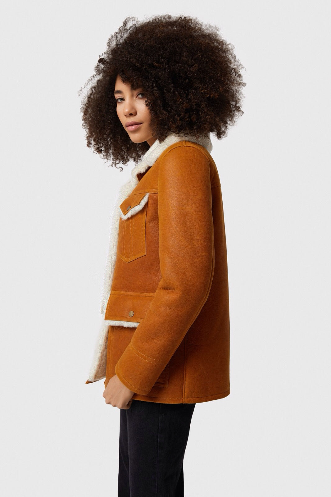 Woman wearing tan shearling coat