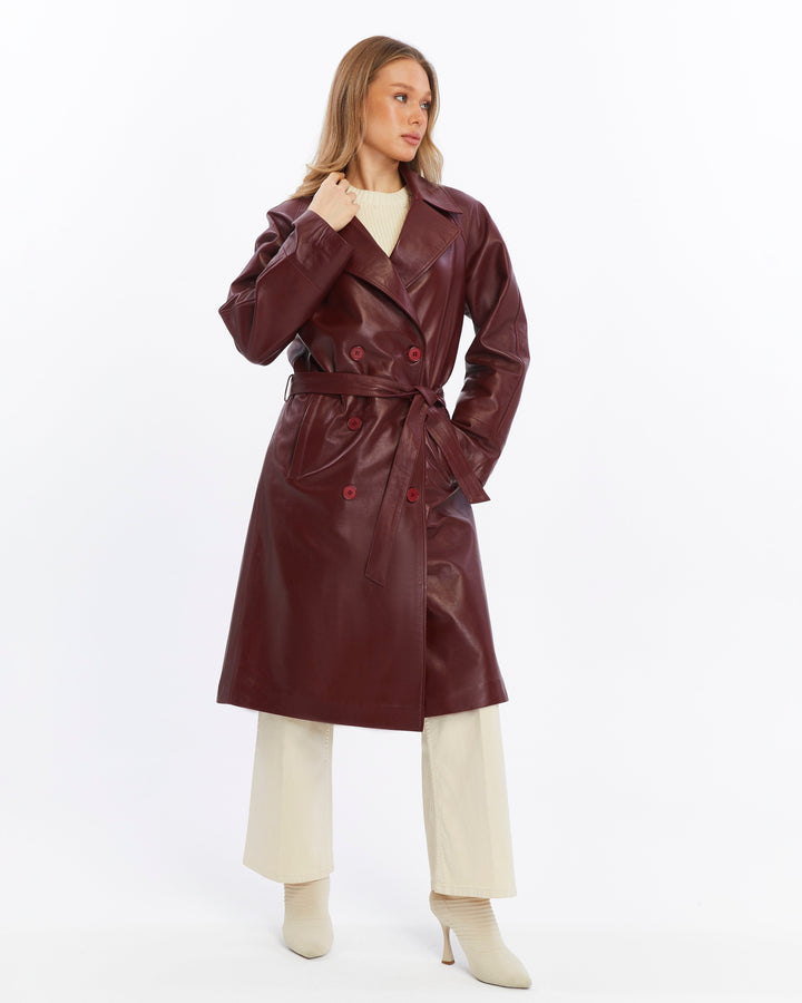Woman wearing maroon leather trench coat