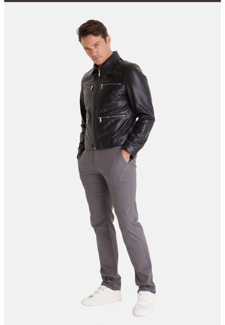 Man wearing black leather jacket and grey trousers