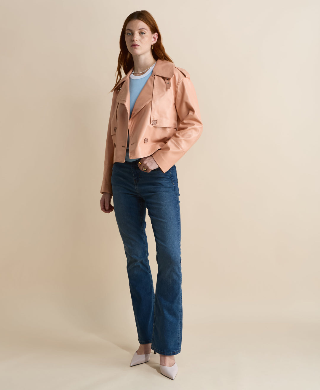 Woman in peach cropped leather jacket