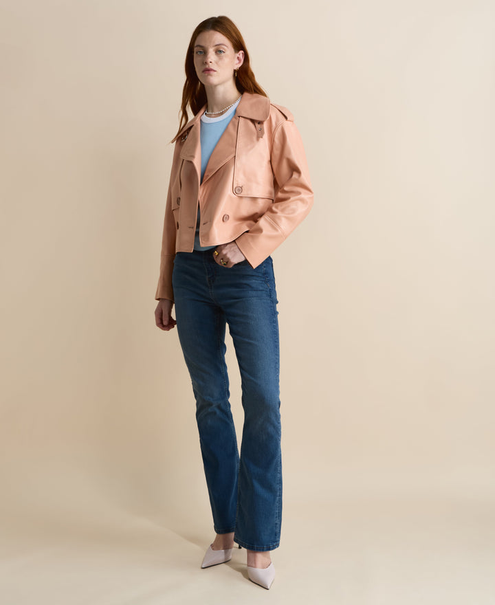 Woman in peach cropped leather jacket