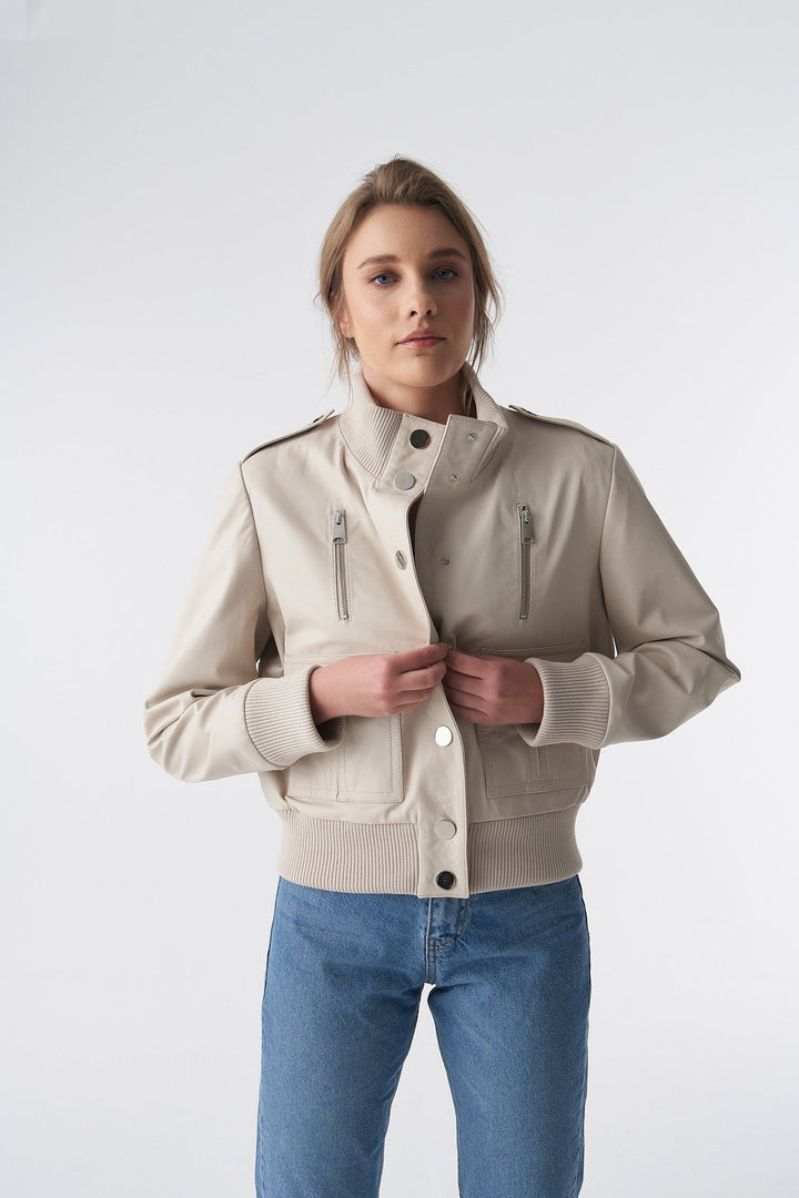 Woman wearing beige bomber jacket