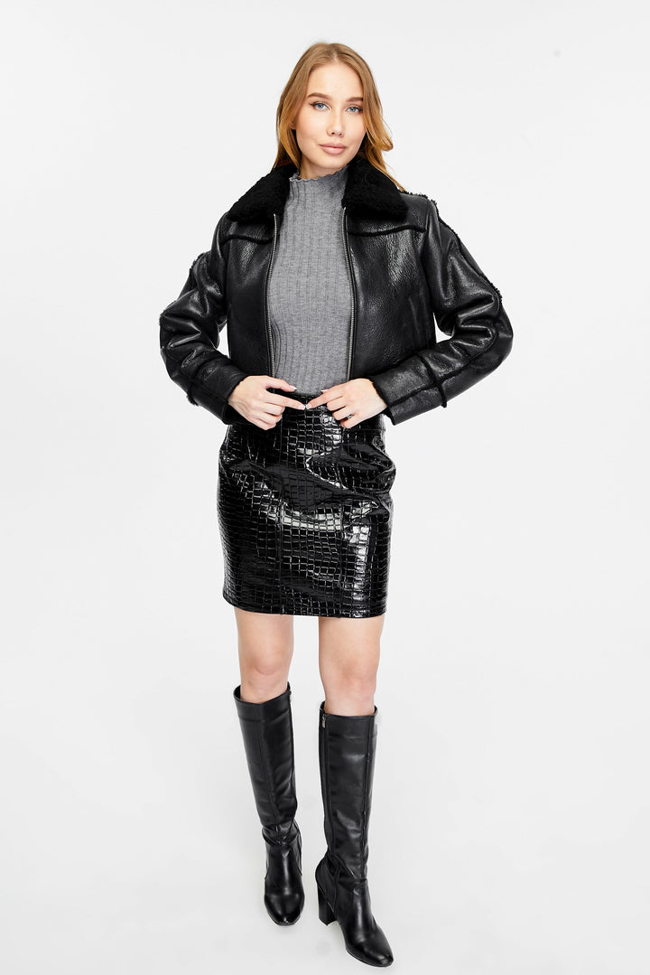 Woman wearing black shearling jacket