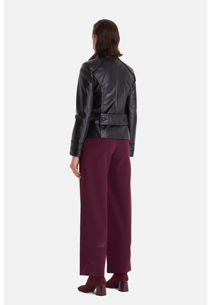 Woman wearing black leather jacket - back view