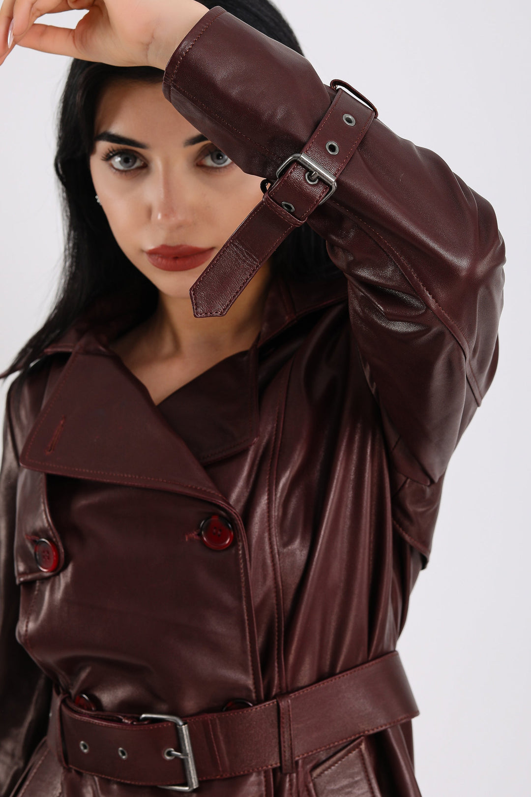 Woman wearing burgundy leather trench coat