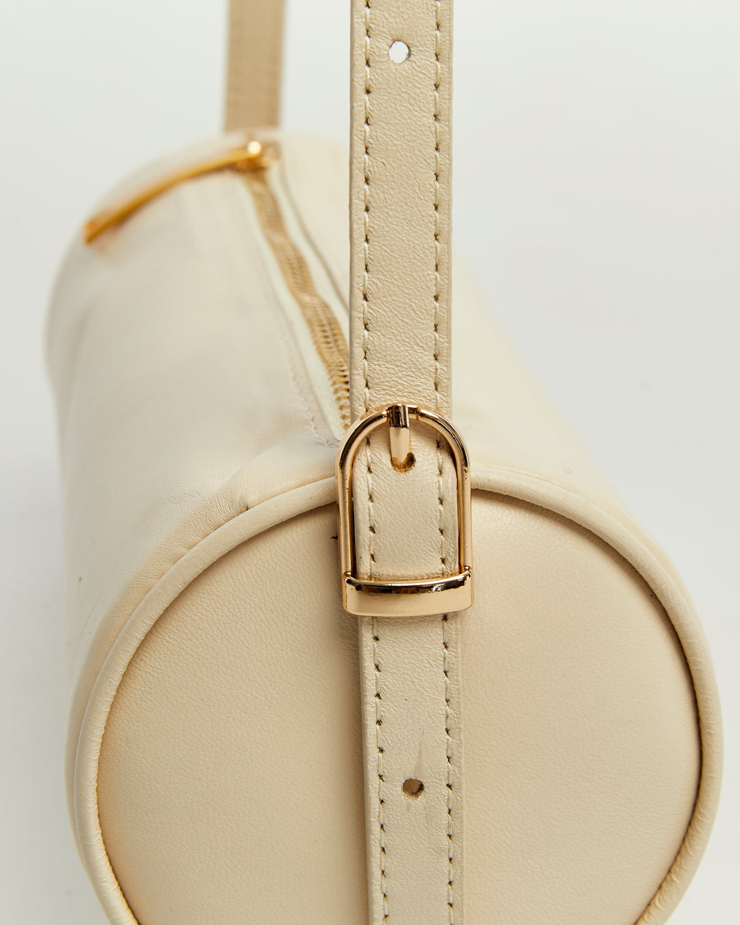Beige cylindrical leather handbag close-up