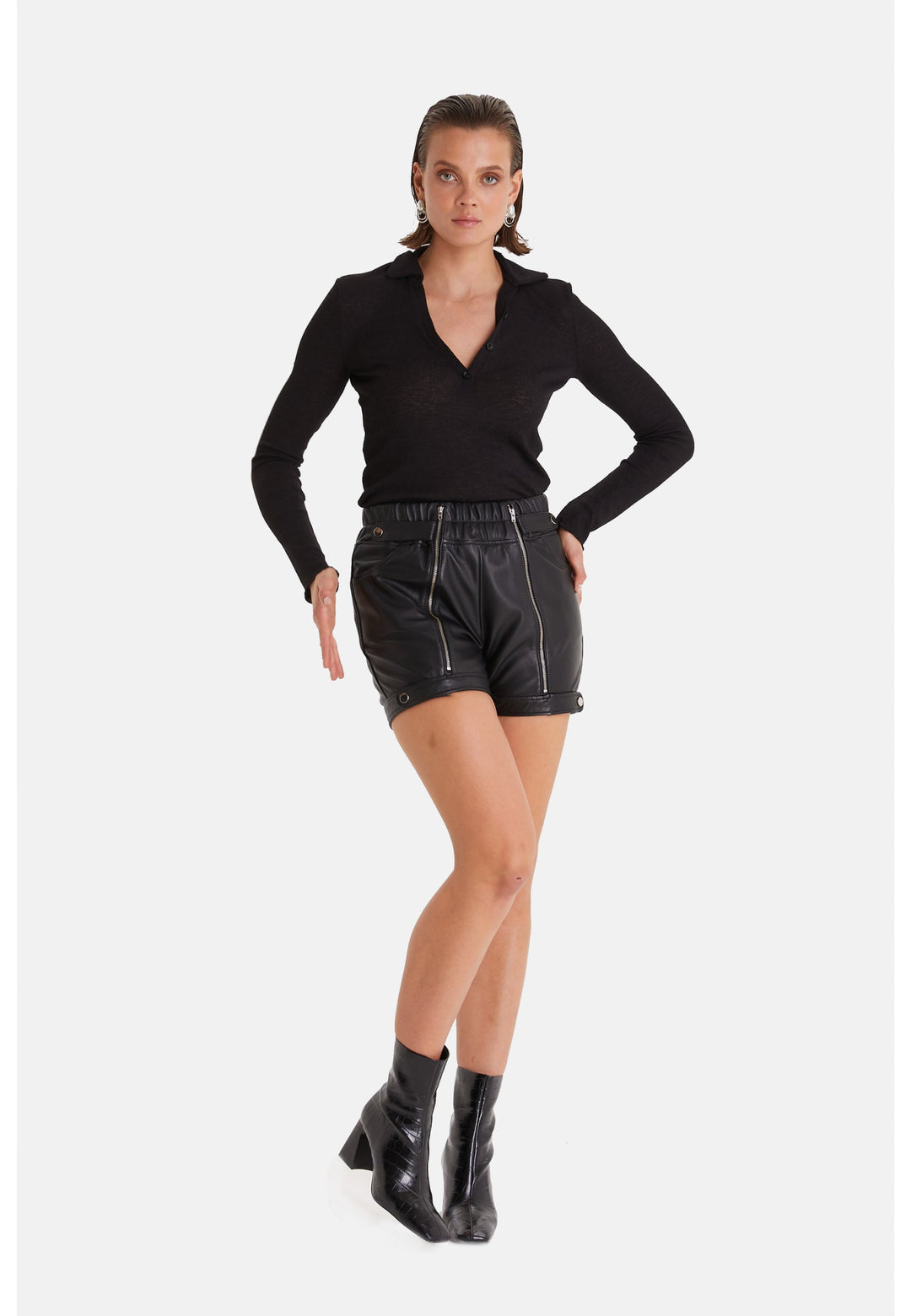 Woman modeling black leather shorts outfit