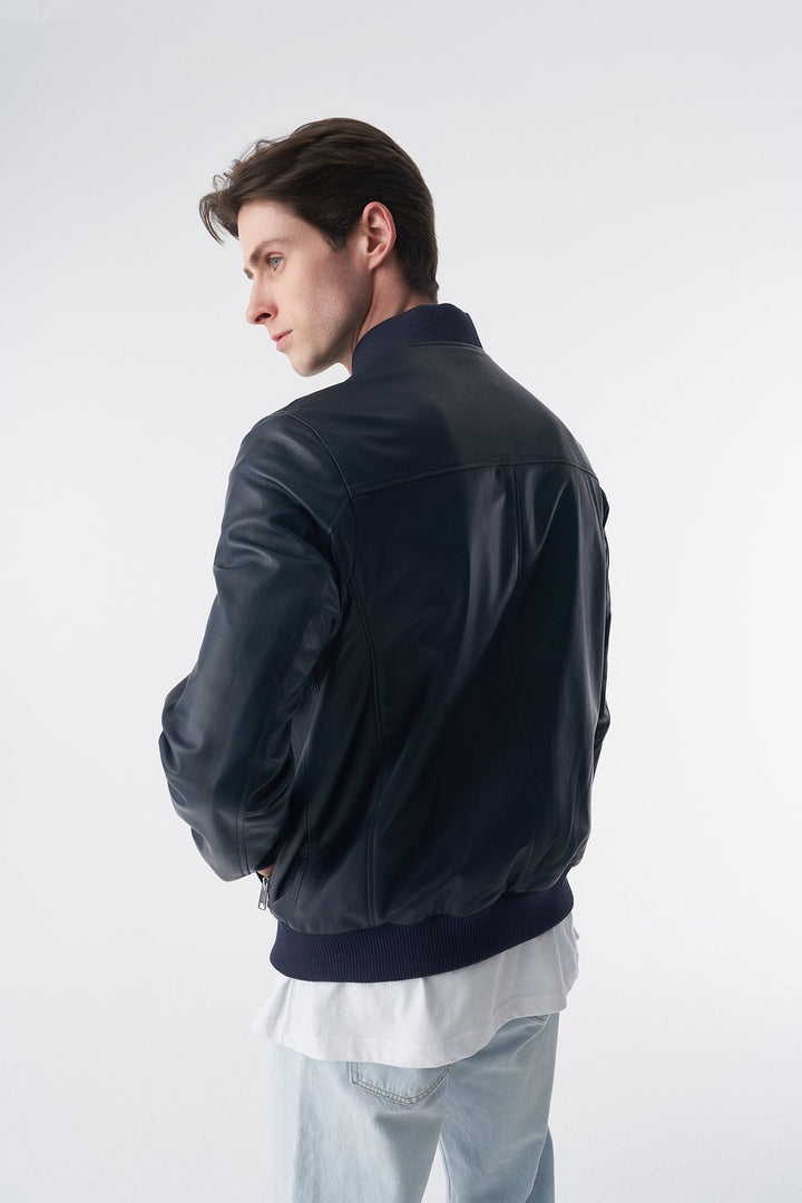 Man wearing dark leather bomber jacket