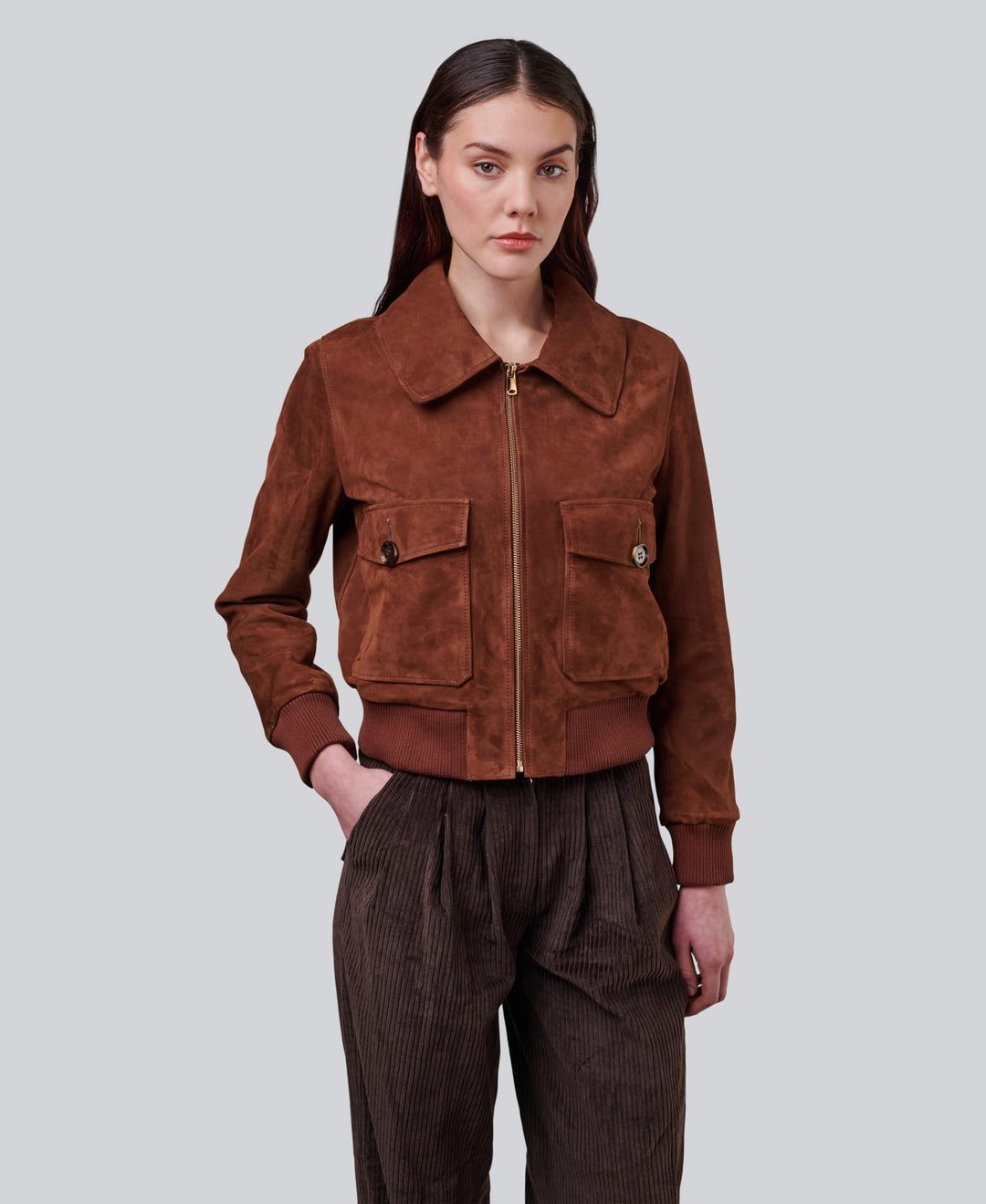 Woman wearing brown suede zip jacket