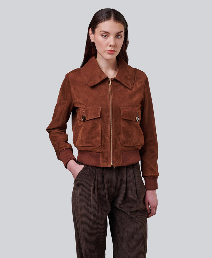 Woman wearing brown suede zip jacket