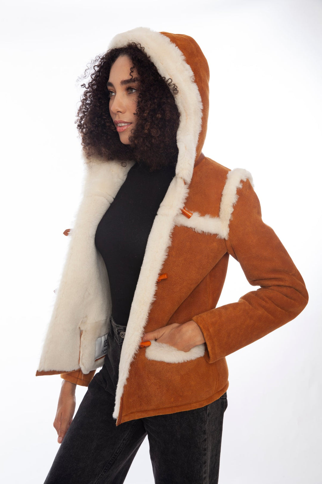 Woman wearing tan sheepskin hooded jacket