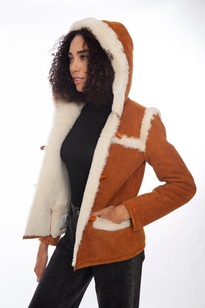 Woman wearing tan sheepskin hooded jacket